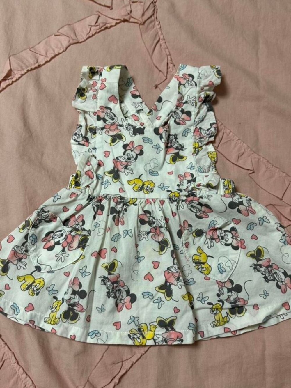 Disney baby girl dress with crisscross adjustable back, ruffle & pocket details.